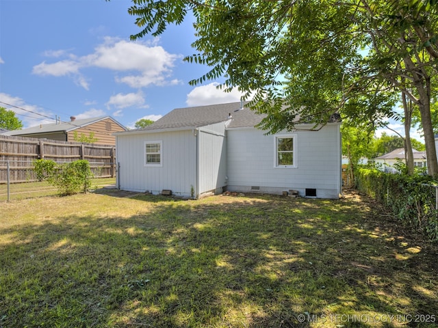 2236 S Marion Ave, Tulsa, OK 74114 - back of property featuring a fenced backyard, roof with shingles, crawl space, and a lawn