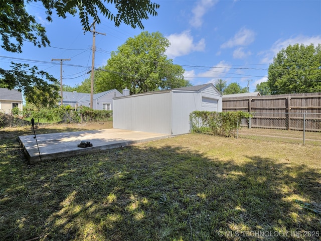 2236 S Marion Ave, Tulsa, OK 74114 - view of yard featuring an outbuilding, a patio, a garage, and fence