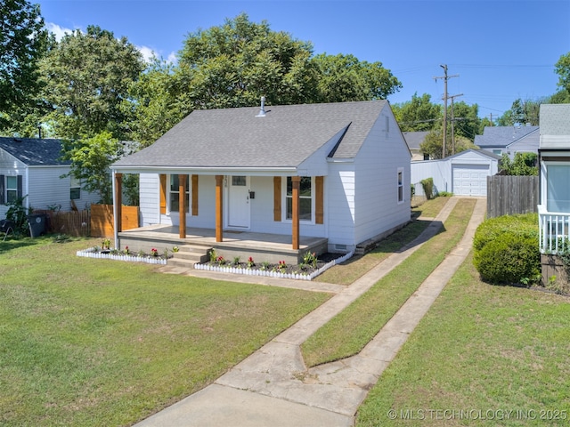 2236 S Marion Ave, Tulsa, OK 74114 - bungalow featuring a porch, roof with shingles, fence, an outdoor structure, and driveway