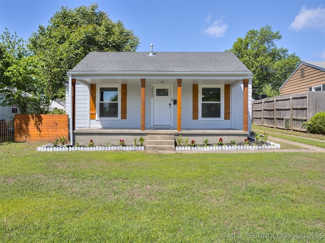 2236 S Marion Ave, Tulsa, OK 74114 - bungalow-style house featuring covered porch, roof with shingles, fence, and a front lawn