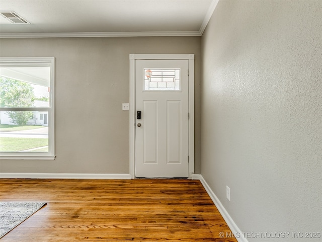2236 S Marion Ave, Tulsa, OK 74114 - entryway featuring crown molding, baseboards, visible vents, and wood finished floors