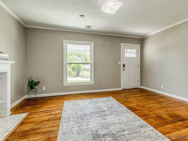 2236 S Marion Ave, Tulsa, OK 74114 - entryway with crown molding, visible vents, wood finished floors, and baseboards