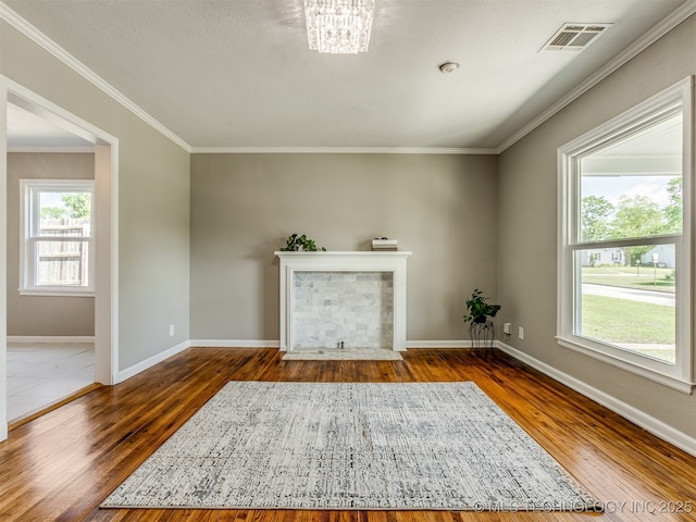 2236 S Marion Ave, Tulsa, OK 74114 - unfurnished living room featuring baseboards, a fireplace with flush hearth, visible vents, and wood finished floors