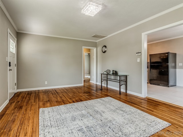 2236 S Marion Ave, Tulsa, OK 74114 - interior space featuring baseboards, ornamental molding, visible vents, and wood finished floors