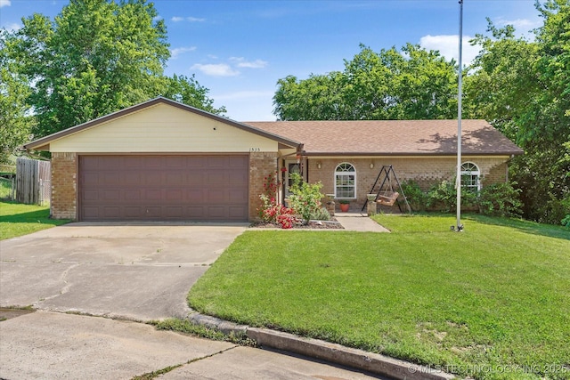 ranch-style home featuring driveway, a garage, brick siding, a front lawn, and a shingled roof