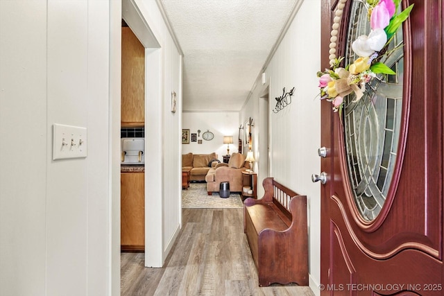 entrance foyer with a textured ceiling and wood finished floors