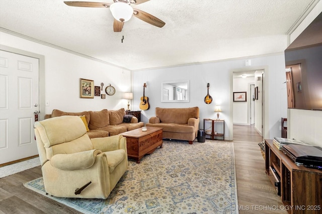 living room with a ceiling fan, a textured ceiling, and wood finished floors