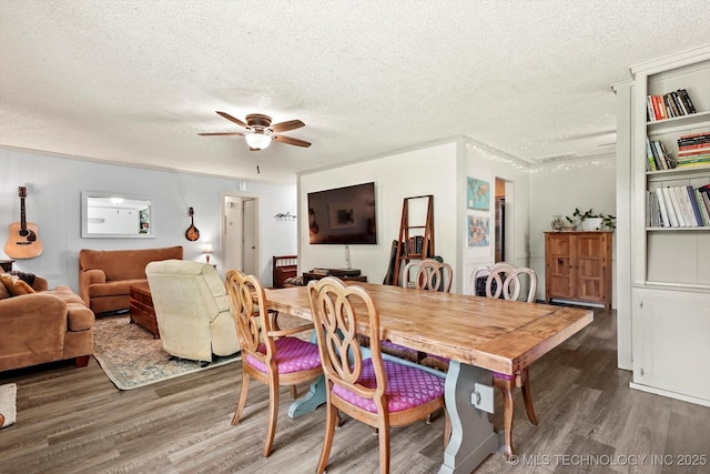 dining room with a textured ceiling, a ceiling fan, and wood finished floors