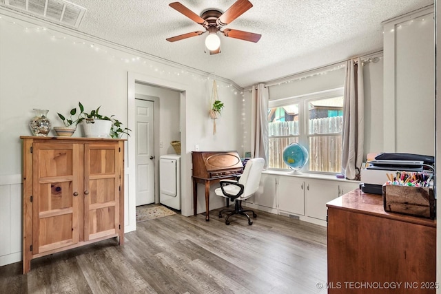 office space featuring a ceiling fan, a textured ceiling, washer / clothes dryer, and light wood finished floors