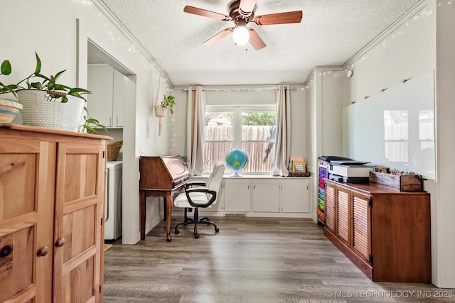 home office featuring a textured ceiling, washer / dryer, ceiling fan, and light wood-type flooring