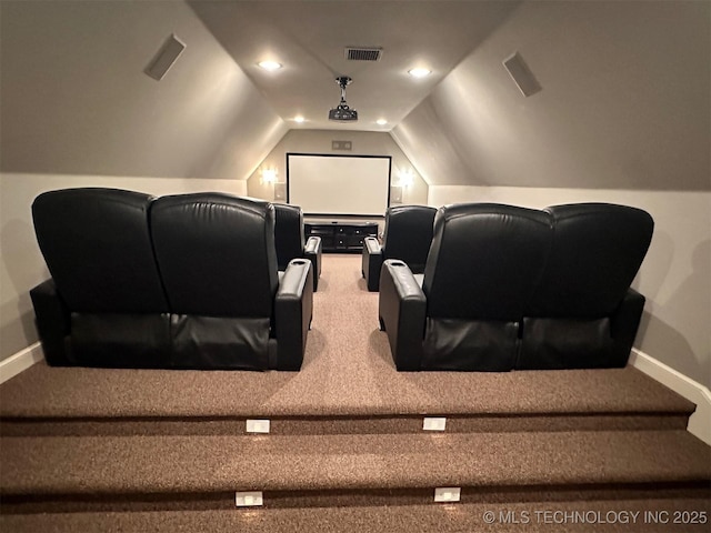 home theater room featuring visible vents, carpet, baseboards, and vaulted ceiling