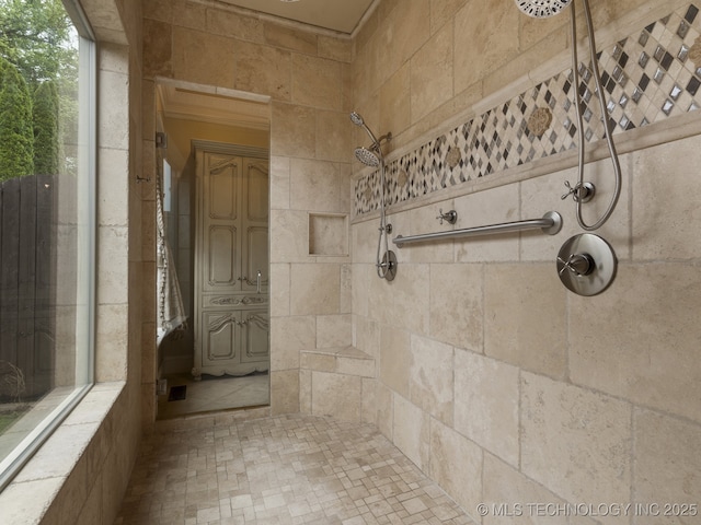 bathroom with a tile shower