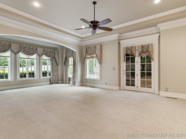 unfurnished room with baseboards, ornamental molding, ceiling fan, and carpet