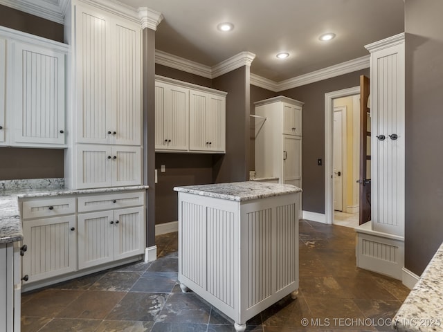 interior space featuring baseboards, recessed lighting, crown molding, and stone finish floor