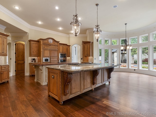 10910 S 69th E Ave, Tulsa, OK 74133 - kitchen with a chandelier, a kitchen breakfast bar, ornamental molding, a large island, and dark wood-style floors
