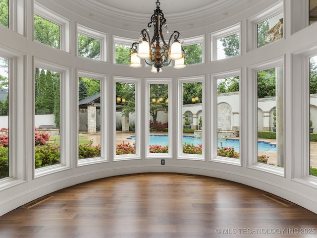 10910 S 69th E Ave, Tulsa, OK 74133 - unfurnished sunroom featuring a chandelier and wood finished floors