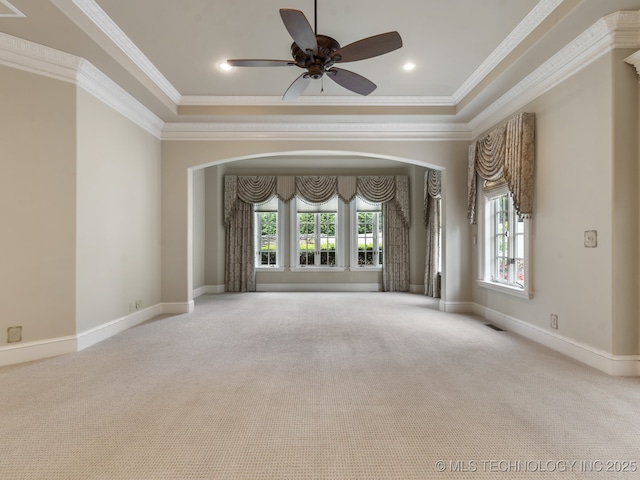 10910 S 69th E Ave, Tulsa, OK 74133 - carpeted empty room with plenty of natural light, arched walkways, a tray ceiling, and ornamental molding