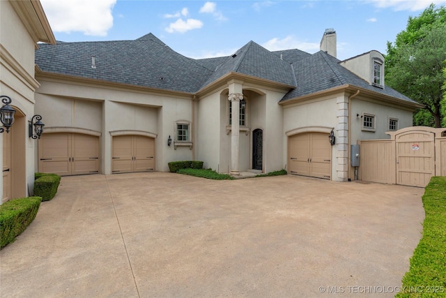 10910 S 69th E Ave, Tulsa, OK 74133 - french provincial home with stucco siding, an attached garage, a gate, and a chimney