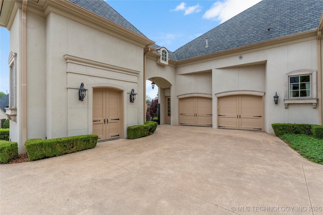 10910 S 69th E Ave, Tulsa, OK 74133 - entrance to property featuring concrete driveway, an attached garage, a high end roof, and stucco siding