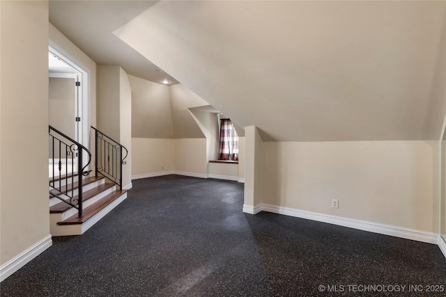 10910 S 69th E Ave, Tulsa, OK 74133 - bonus room featuring lofted ceiling, dark flooring, and stairway
