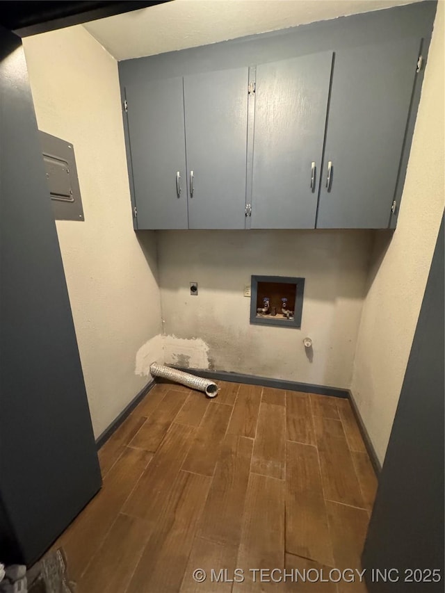 washroom with cabinet space, hookup for a washing machine, gas dryer hookup, electric dryer hookup, and wood tiled floor