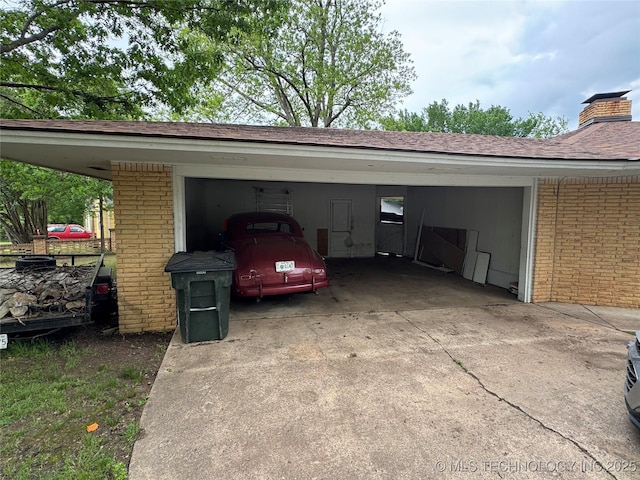 garage featuring driveway and a carport