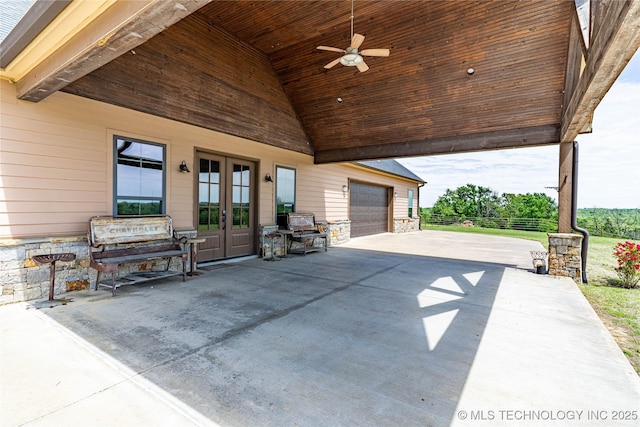 view of patio / terrace featuring a ceiling fan, driveway, french doors, and fence
