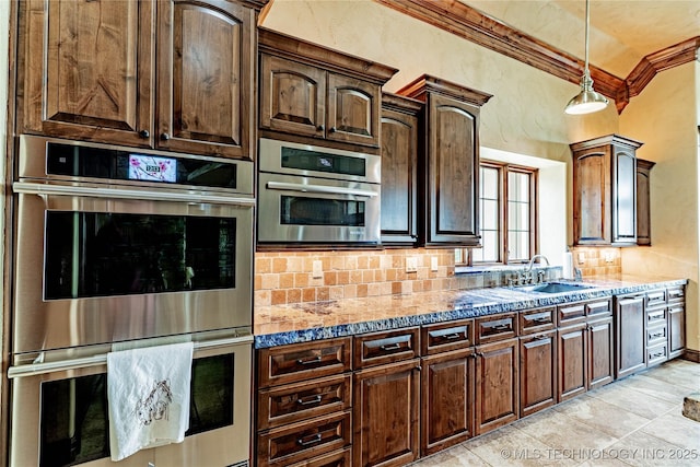 kitchen with crown molding, light stone countertops, double oven, and a sink