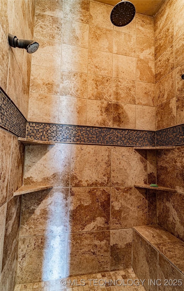 interior details with a tile shower