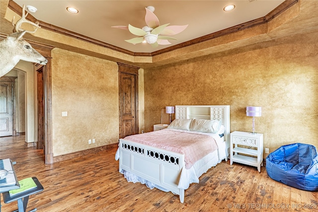bedroom with ornate columns, recessed lighting, ornamental molding, and wood finished floors
