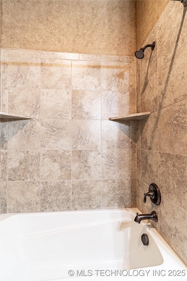 interior details with bathtub / shower combination