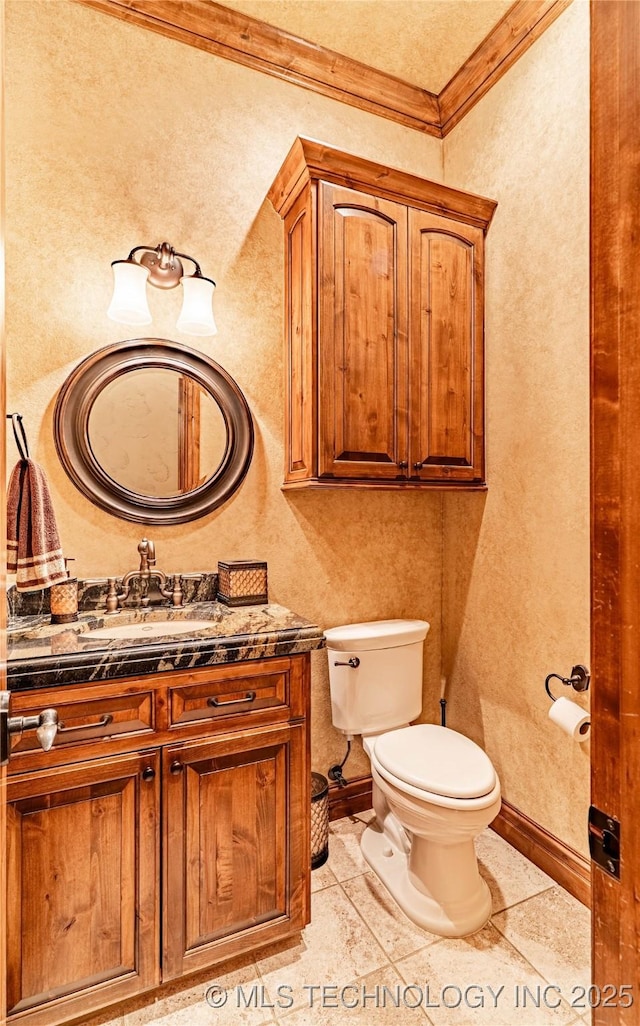 bathroom with vanity, ornamental molding, a textured wall, and toilet