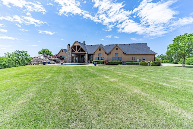 rear view of house with a lawn