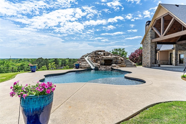 view of swimming pool featuring a fenced in pool, fence, a water slide, and a patio
