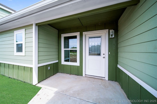 property entrance featuring board and batten siding