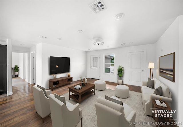 living area featuring recessed lighting, baseboards, visible vents, and wood finished floors