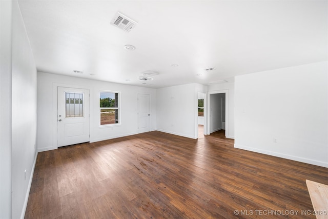 interior space featuring visible vents, baseboards, and dark wood-style flooring