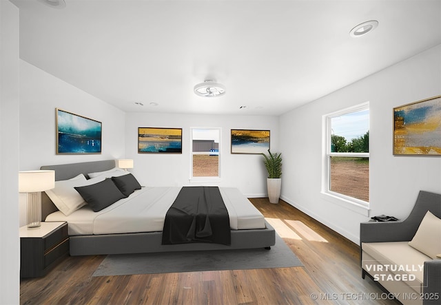 bedroom featuring baseboards, recessed lighting, and wood finished floors