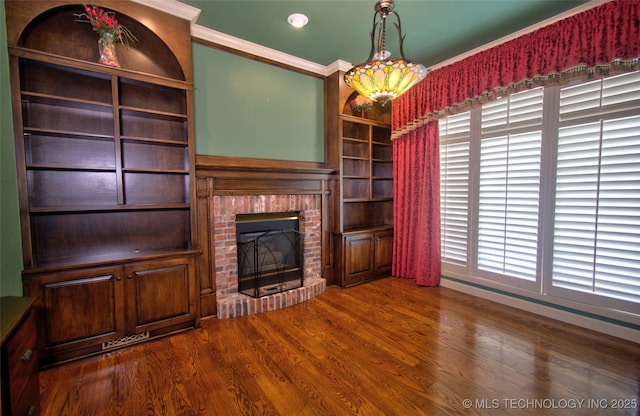 unfurnished living room with ornamental molding, a brick fireplace, recessed lighting, and wood finished floors