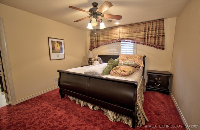 carpeted bedroom featuring ceiling fan, visible vents, and baseboards