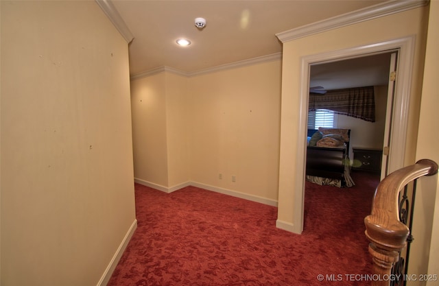 interior space featuring baseboards, ornamental molding, and carpet