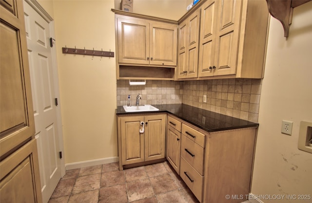 kitchen featuring baseboards, a sink, decorative backsplash, and open shelves