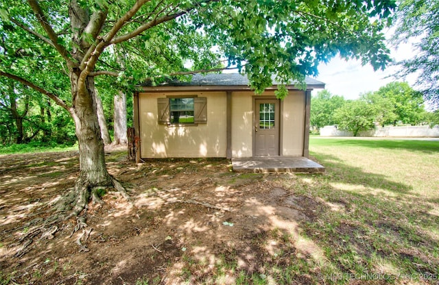 view of outbuilding with fence and an outbuilding