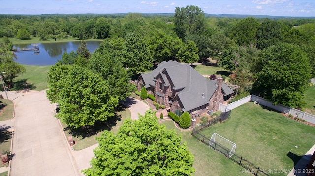 aerial view featuring a water view and a forest view