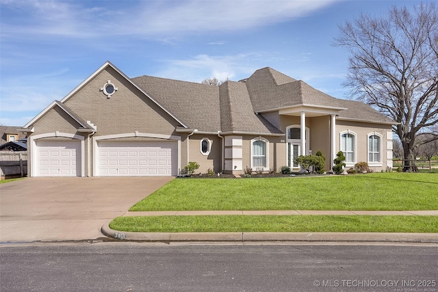 view of front of home featuring a garage, a shingled roof, concrete driveway, and a front yard