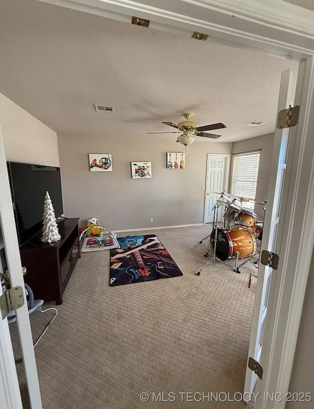 game room featuring baseboards, ceiling fan, carpet, and visible vents