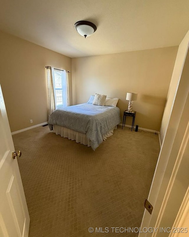 bedroom with carpet floors and baseboards