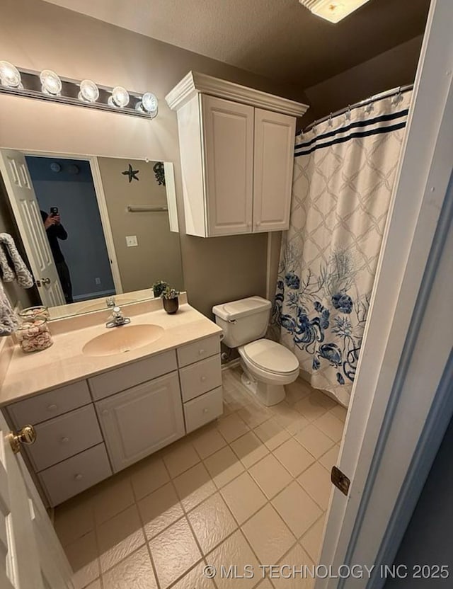 bathroom featuring tile patterned flooring, curtained shower, toilet, and vanity