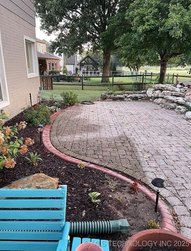 view of yard featuring fence and a patio