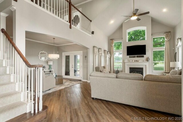 3401 N Narcissus Ave, Broken Arrow, OK 74012 - living area with high vaulted ceiling, dark wood-type flooring, a ceiling fan, a fireplace, and stairs